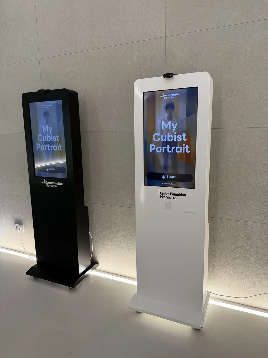 전시장 벽면 조명 아래 나란히 설치된 블랙·화이트 키오스크 2대 — 퐁피두센터 한화